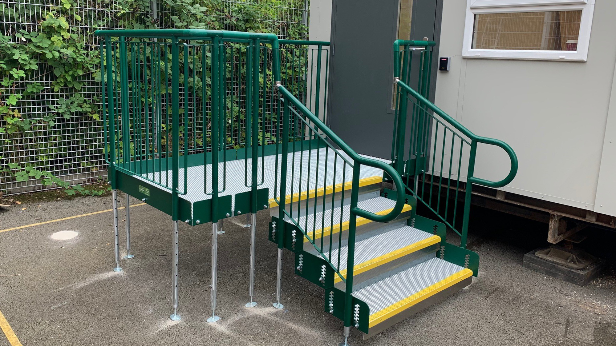 Image shows a step unit outside a temporary building