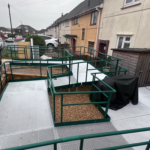Image shows a modular ramp with multiple turns outside a house