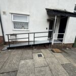Image shows a modular ramp outside the front door of a house