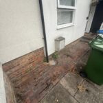 Image shows the narrow space outside a front door before a modular ramp is installed